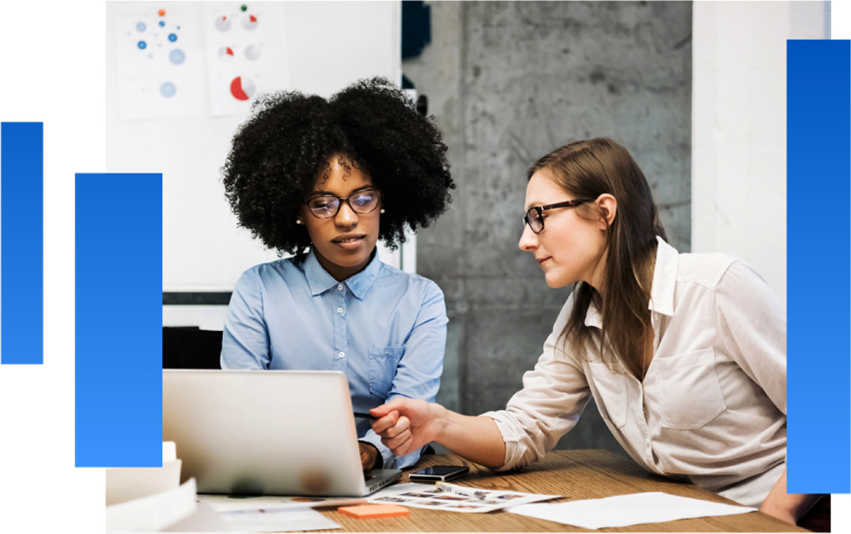 Photo of two people working at a laptop