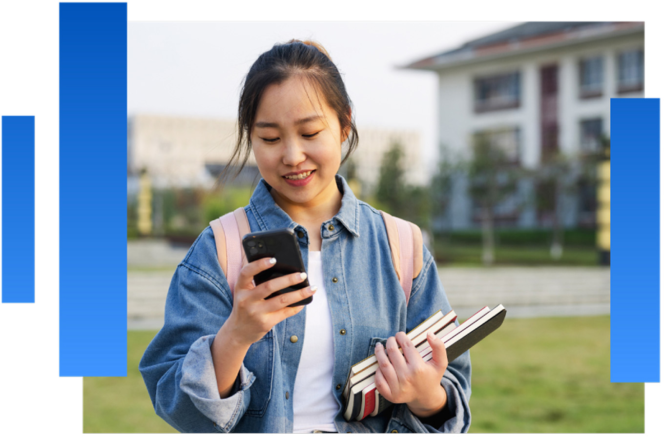 Photo of a student on campus looking at their phone