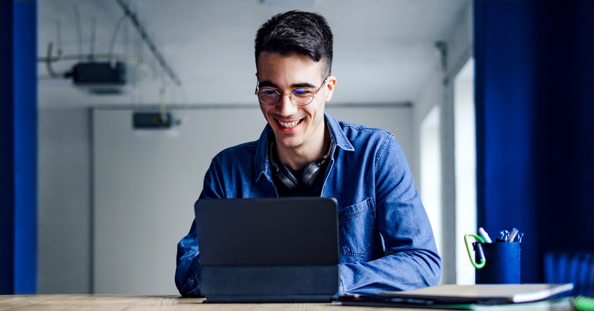 Photo of a person working at a laptop