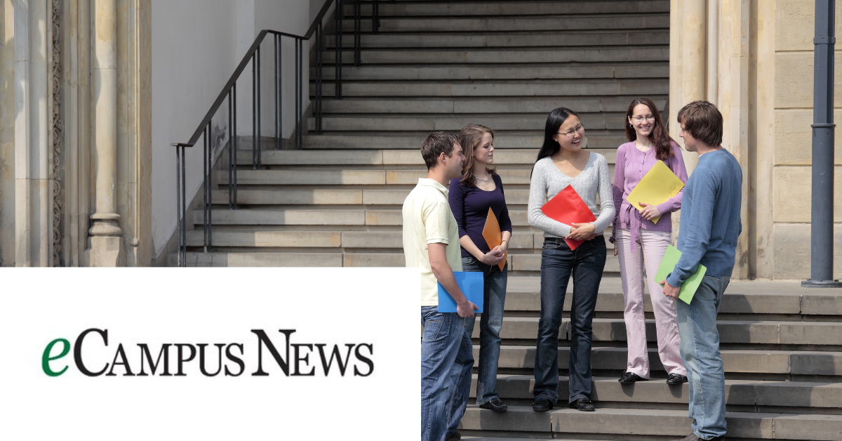 Image of a group of students standing and chatting by the stairs.