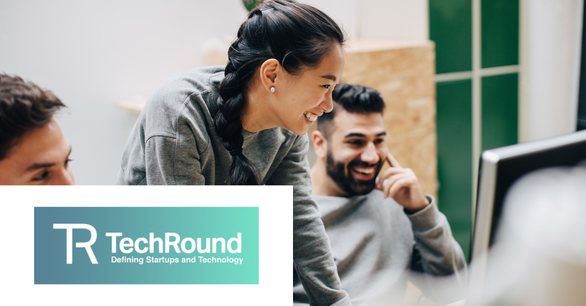 TechRound logo on the bottom left. Image of people looking at a computer smiling on the right.