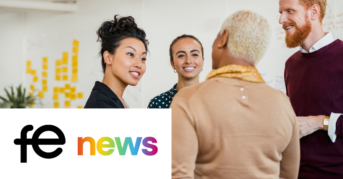 Photo of four people standing around talking