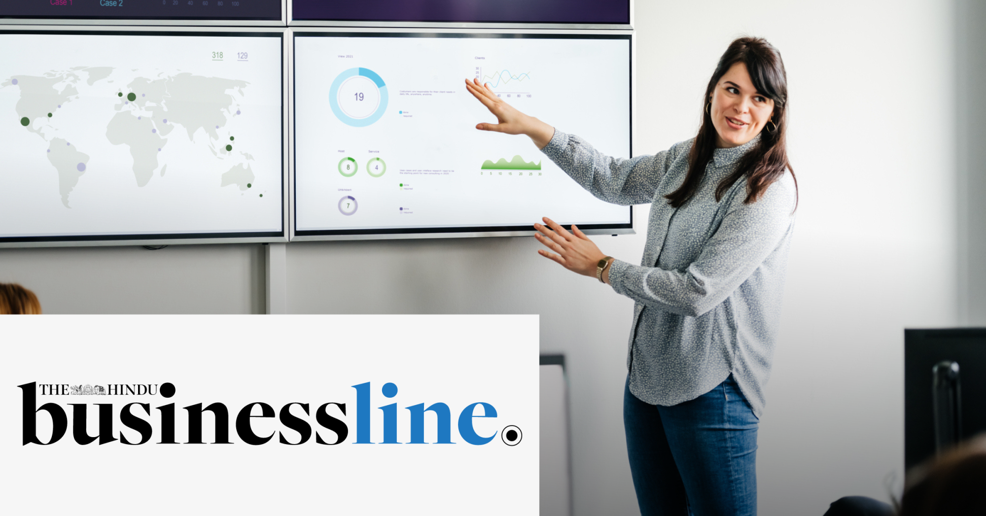 Image of a woman presenting a report to an audience using some screens. On the lower left corner of the image is placed The Hindu Business Line logo. 