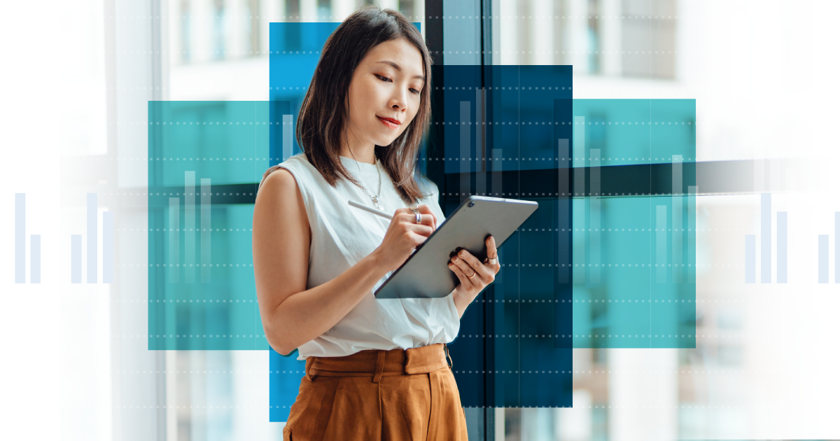 Photo of a woman standing and working on a tablet