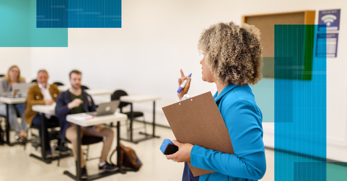 Photo of an instructor in front of a class of learners