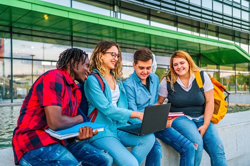 students collaborating together on a laptop