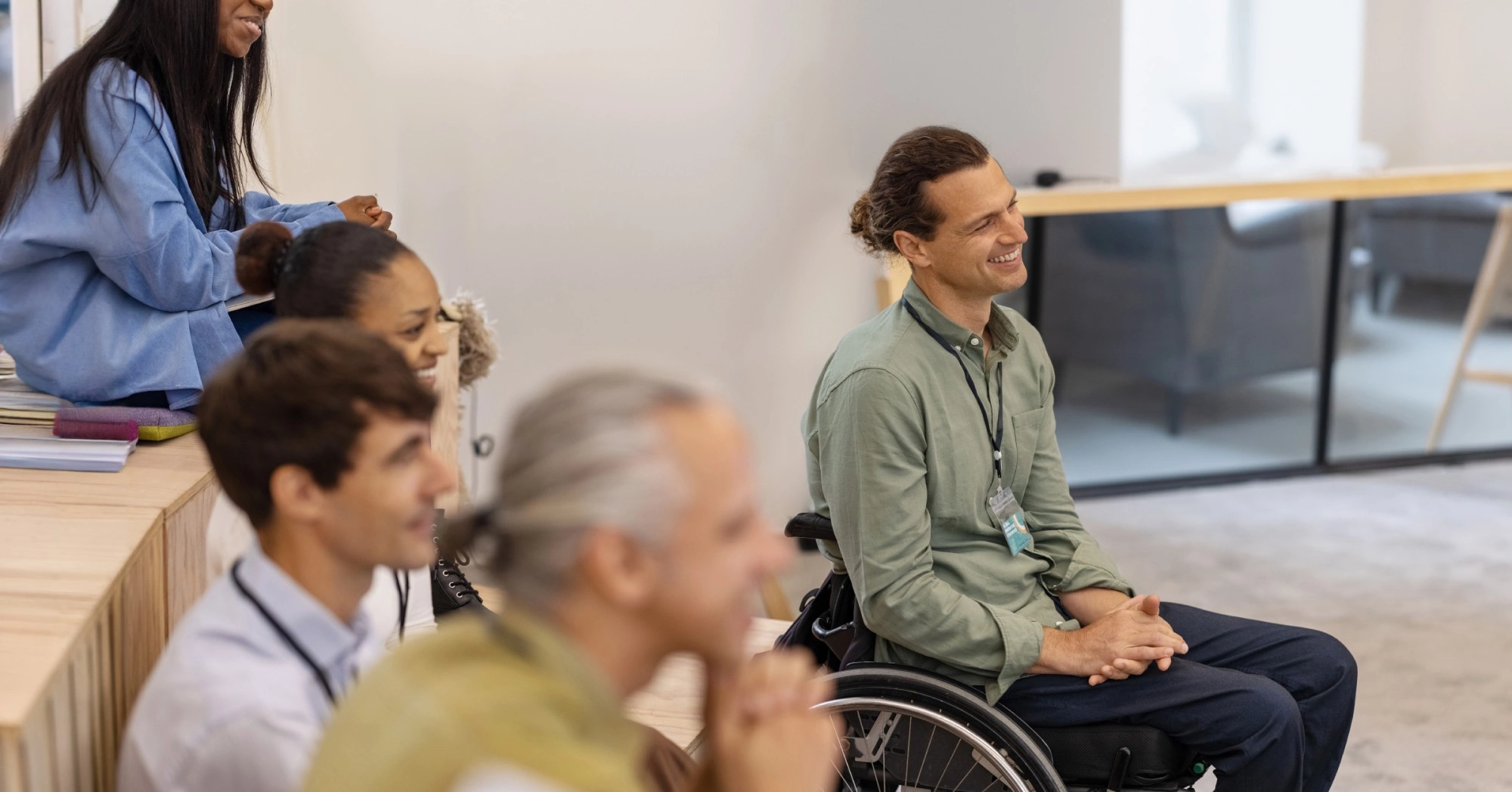 Photo of students in a classroom setting, one of whom is in a wheelchair