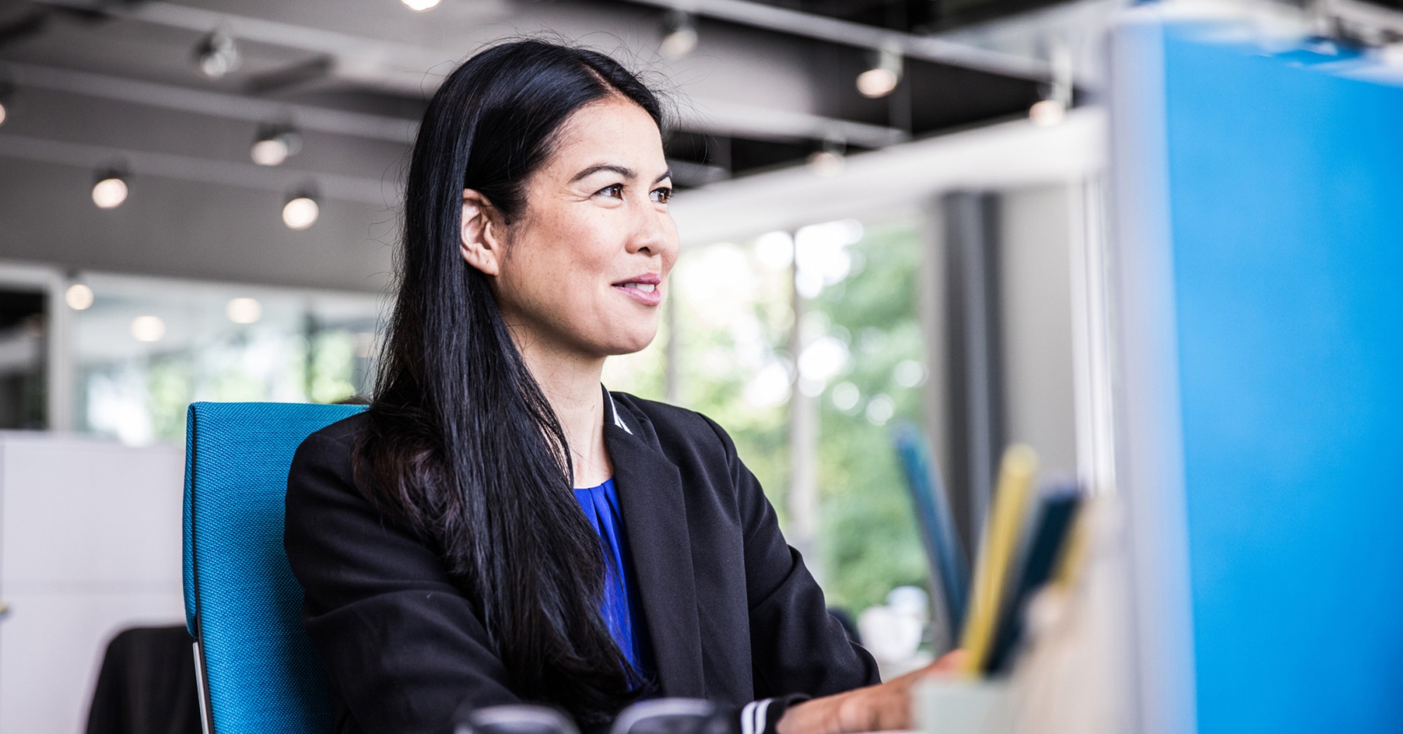 Photo of a person working at a computer in an office setting