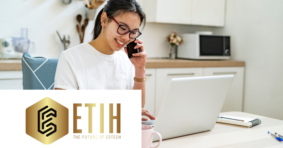 Image of woman talking on the phone while smiling at her laptop